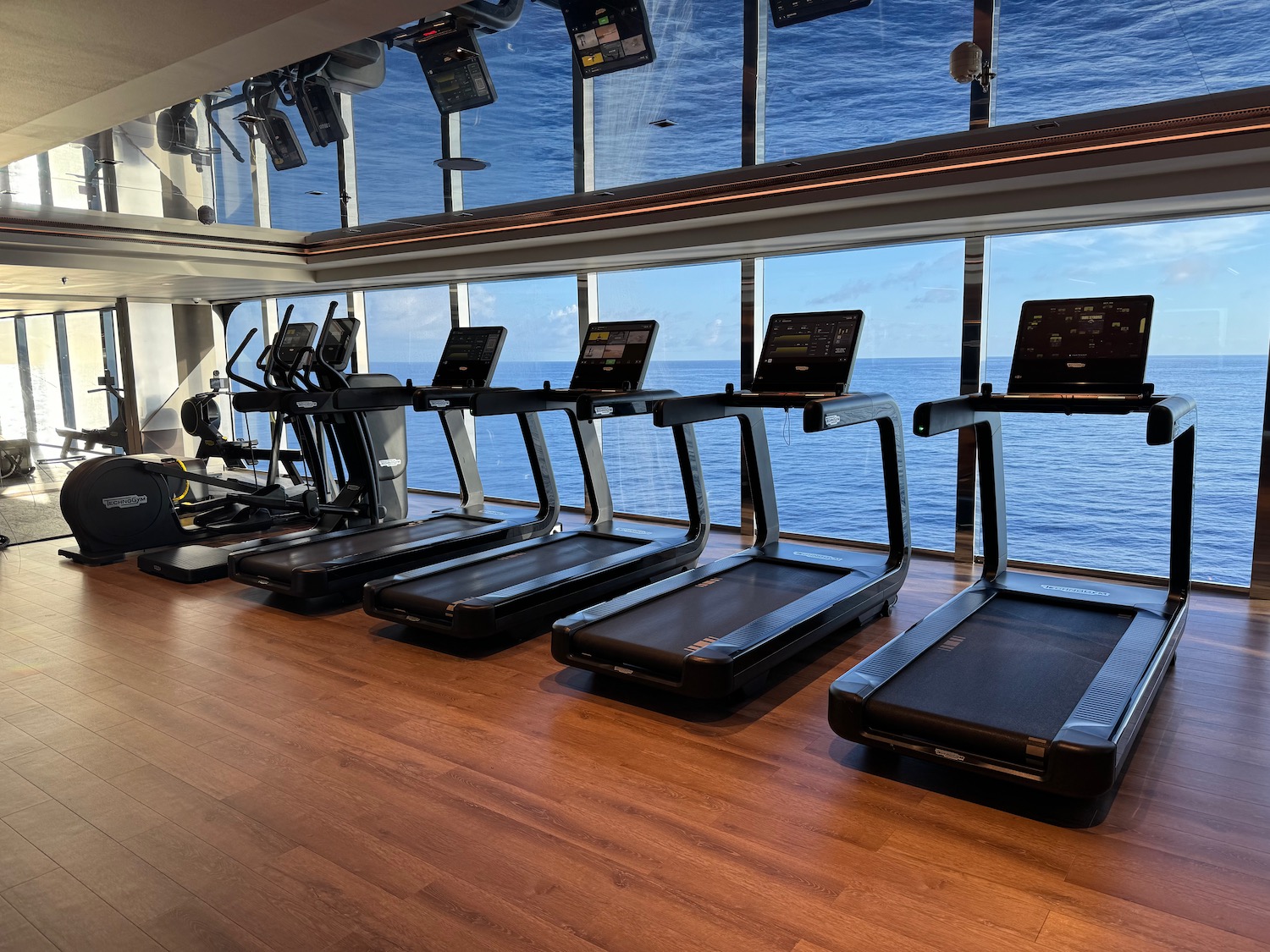 a room with treadmills and computers