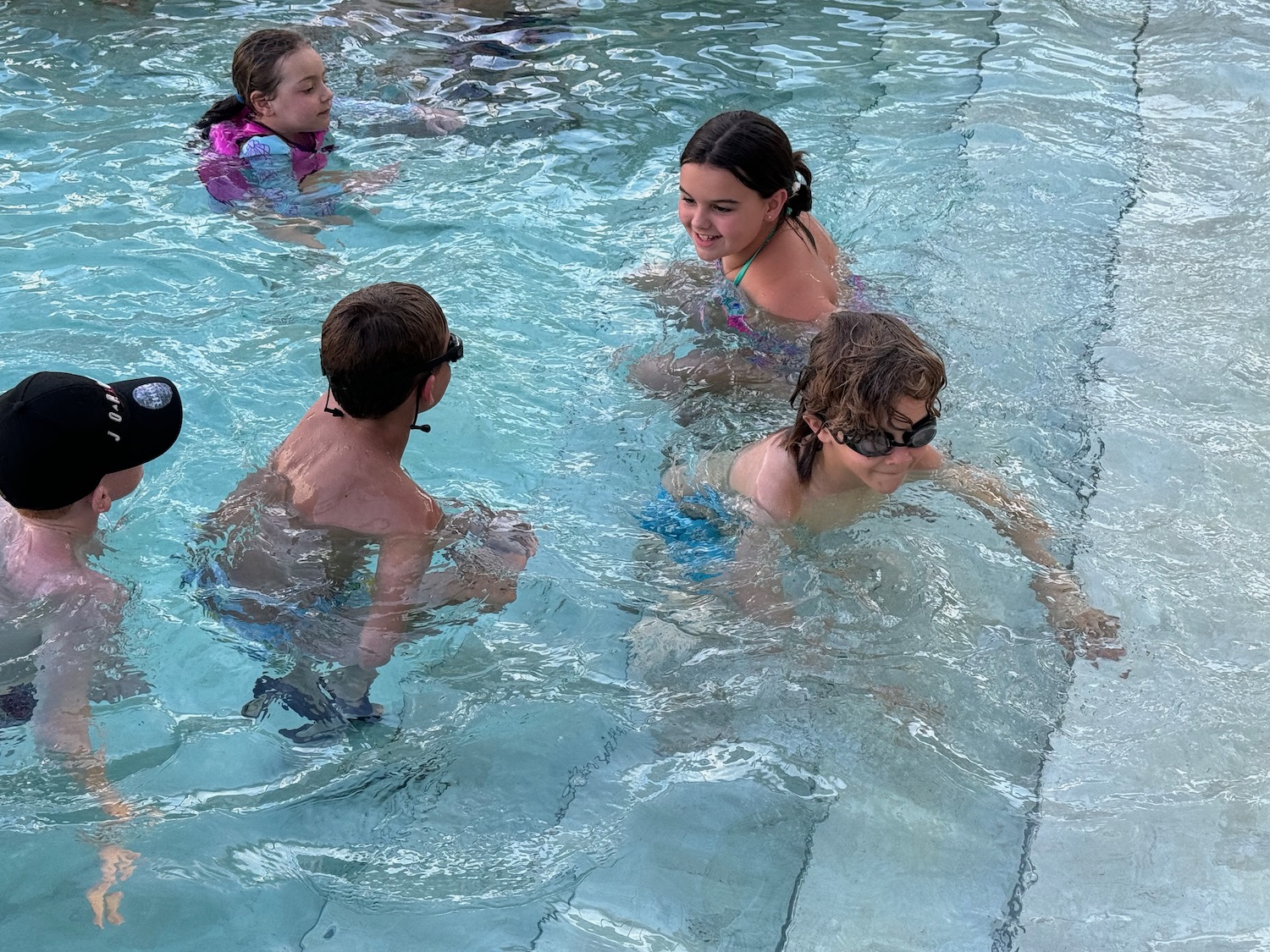 a group of kids in a pool