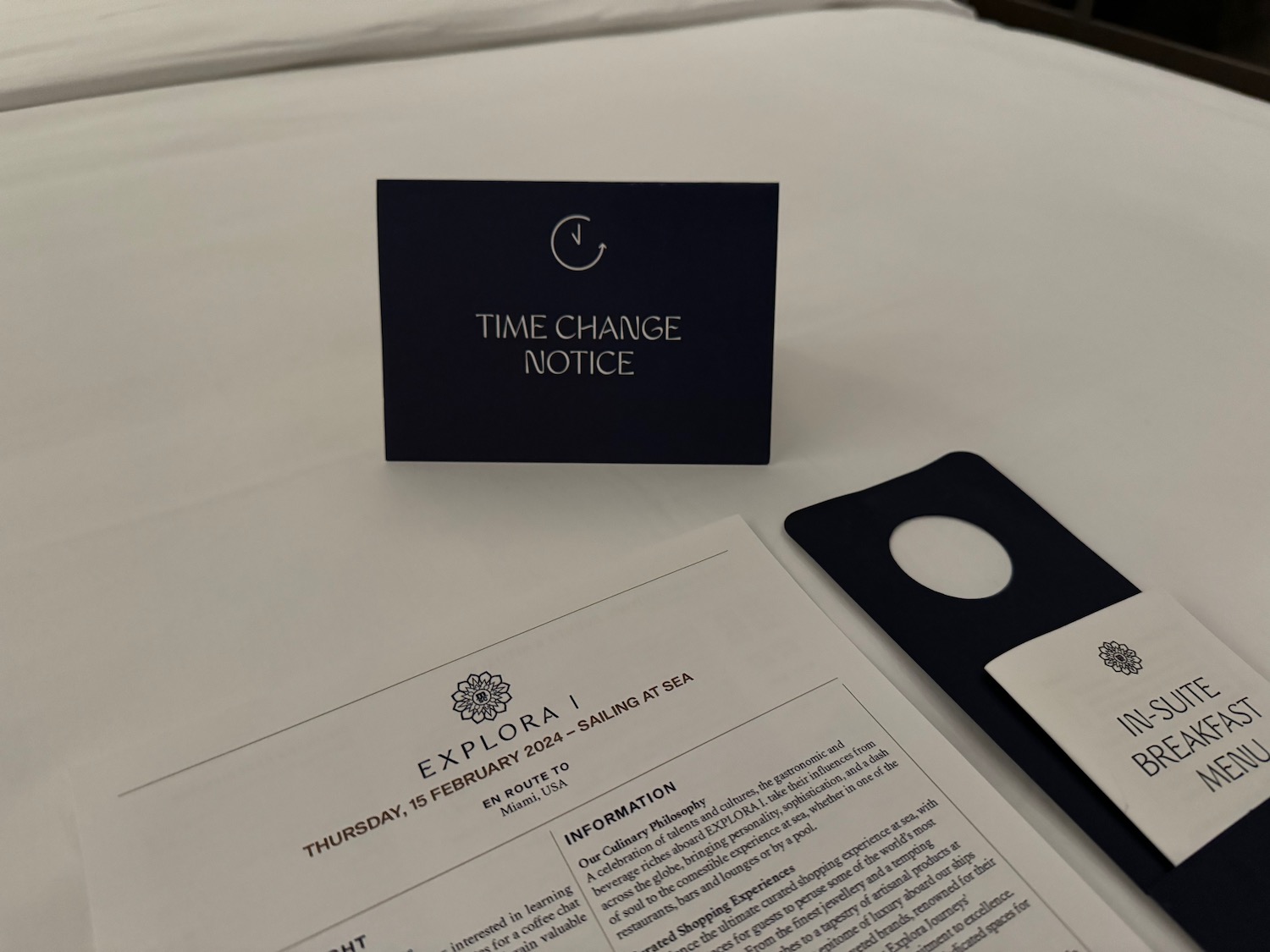 a card and a document on a bed