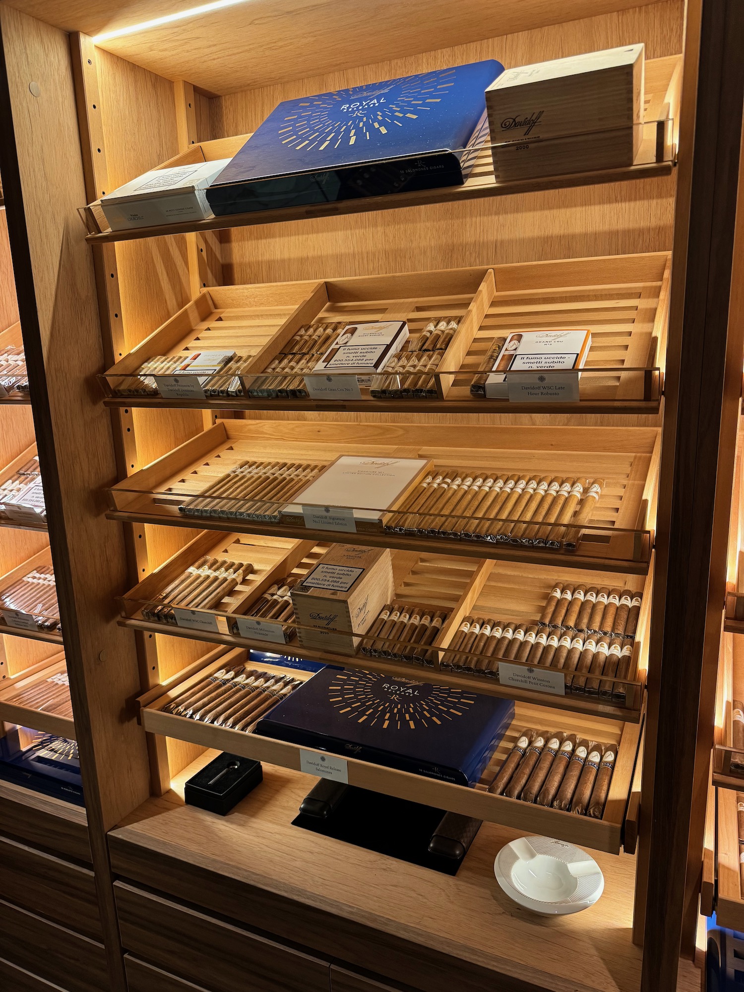 a shelf with different cigars and cigarettes