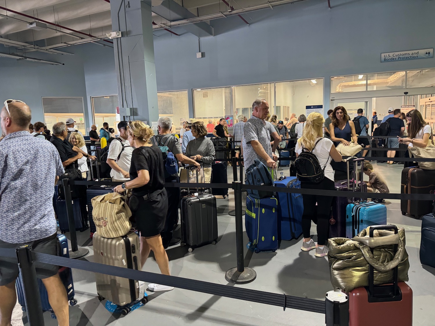 a group of people standing in a line with luggage