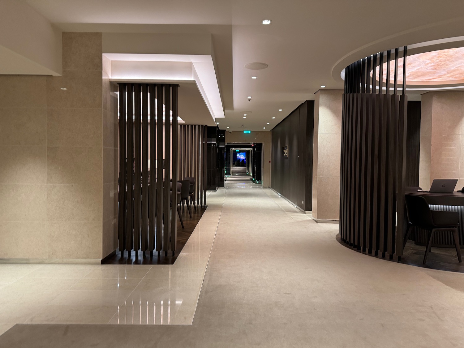 a hallway with columns and a round wall