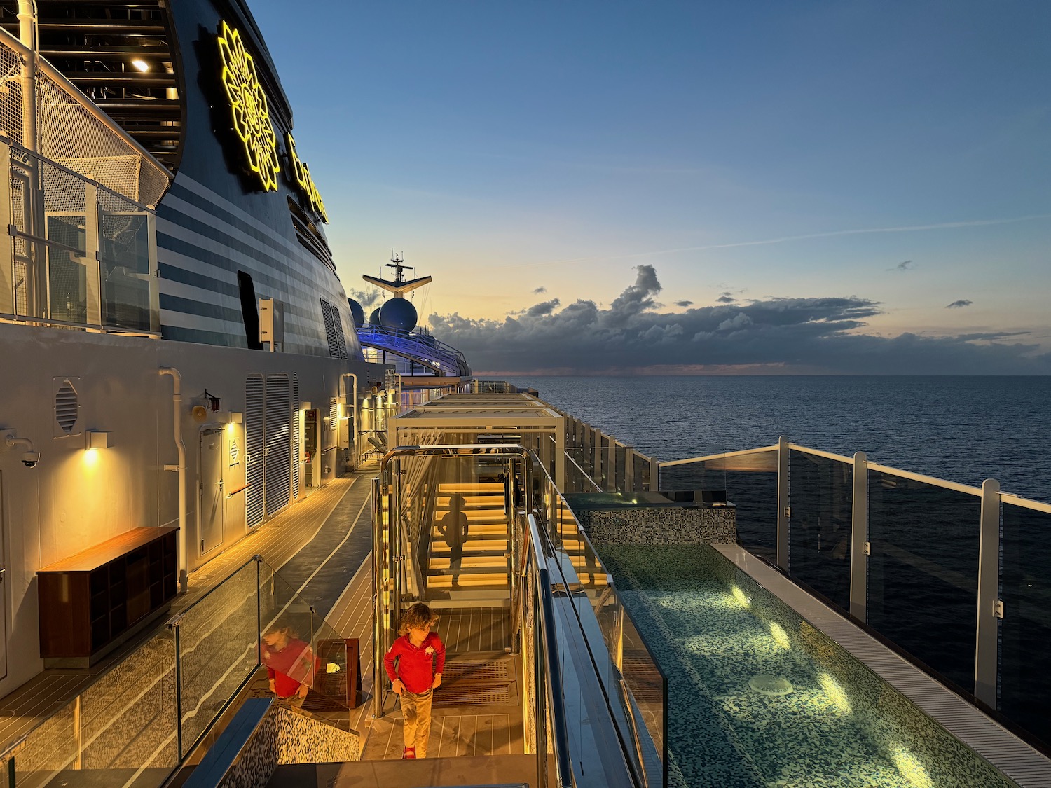 a child walking on a deck of a cruise ship