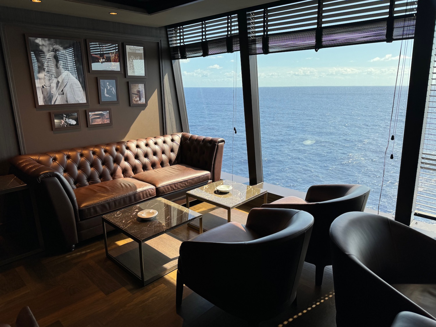 a room with couches and chairs overlooking the water