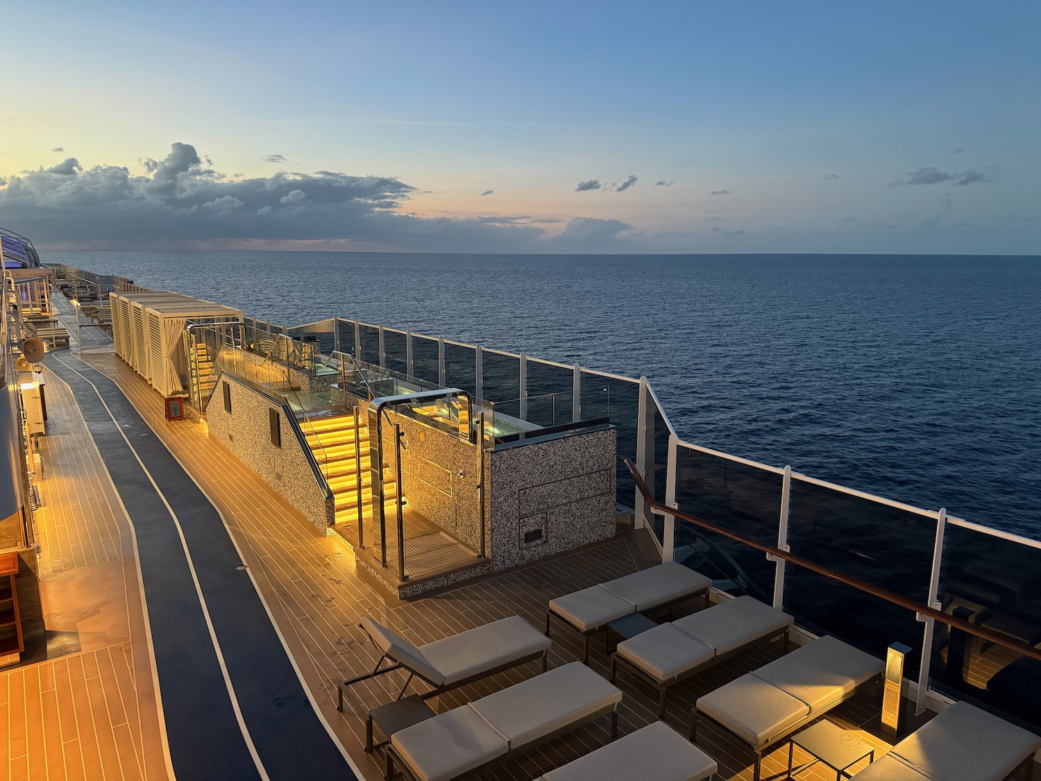 a deck of a cruise ship with a deck and chairs on the deck