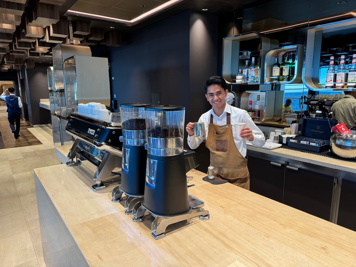 a man standing behind a counter with coffee beans