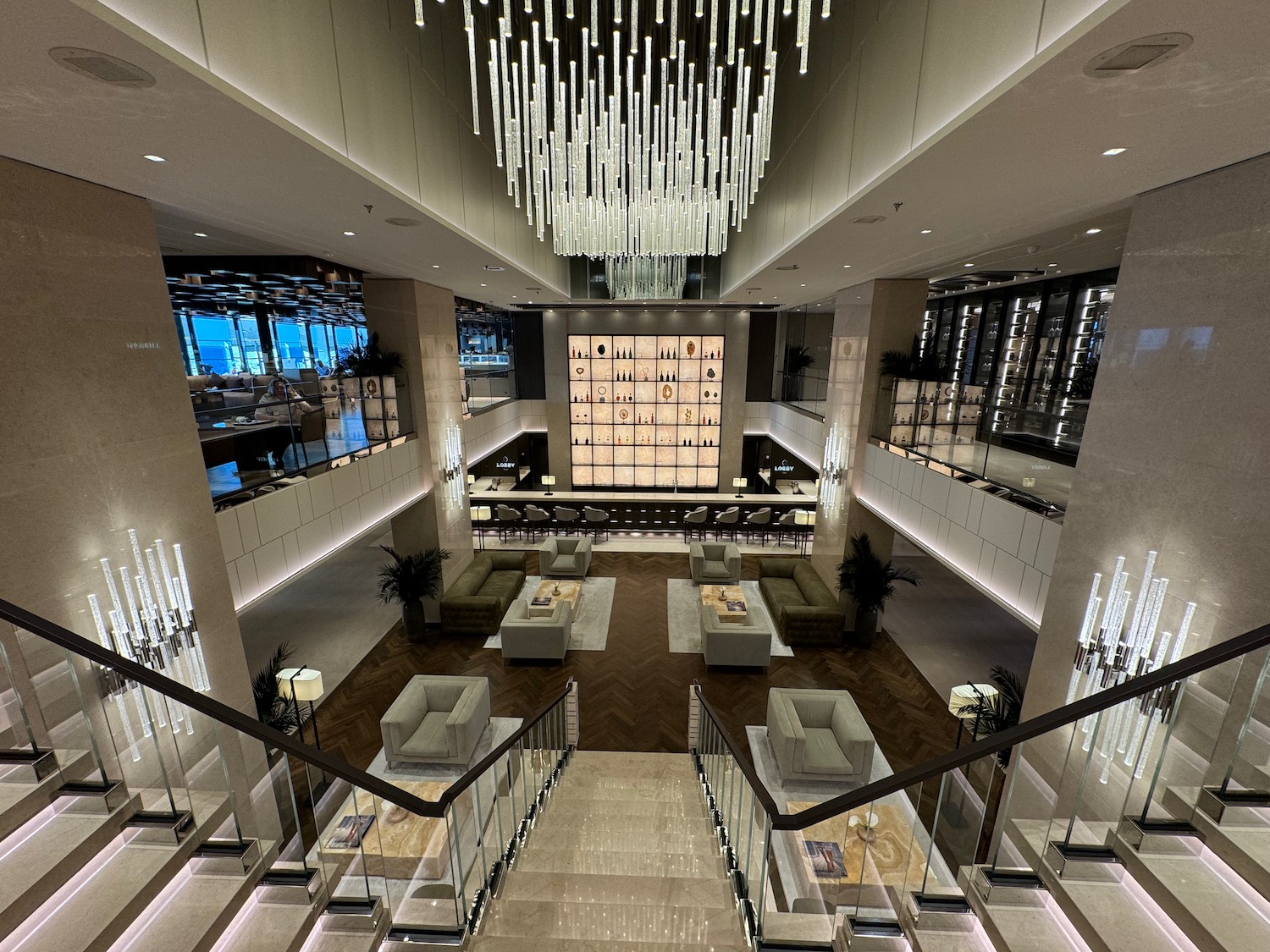 a large room with a chandelier and stairs