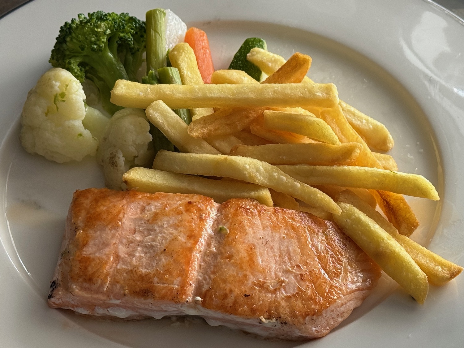 a plate of food with a piece of salmon and french fries