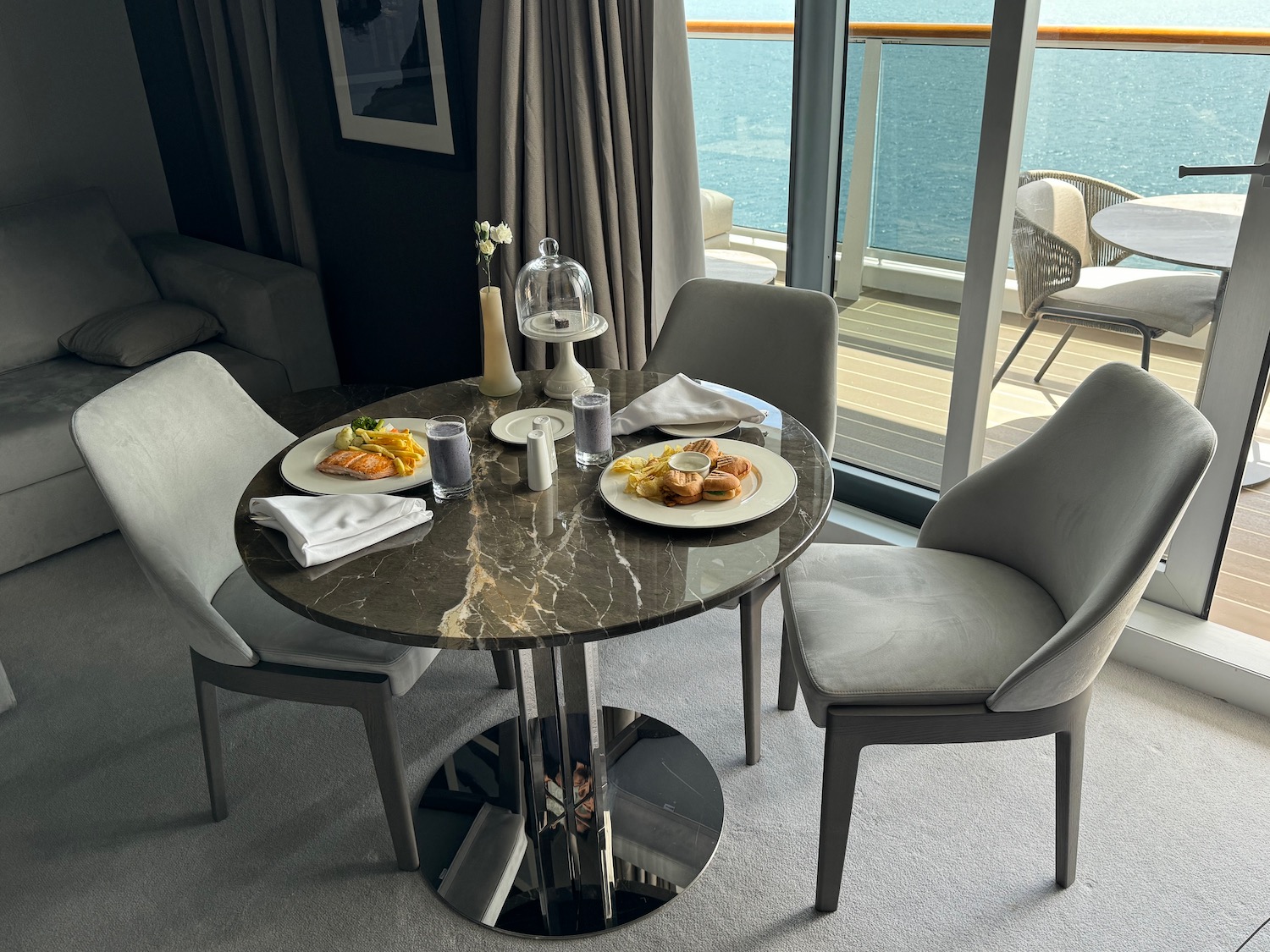 a table with food on it and chairs by a window