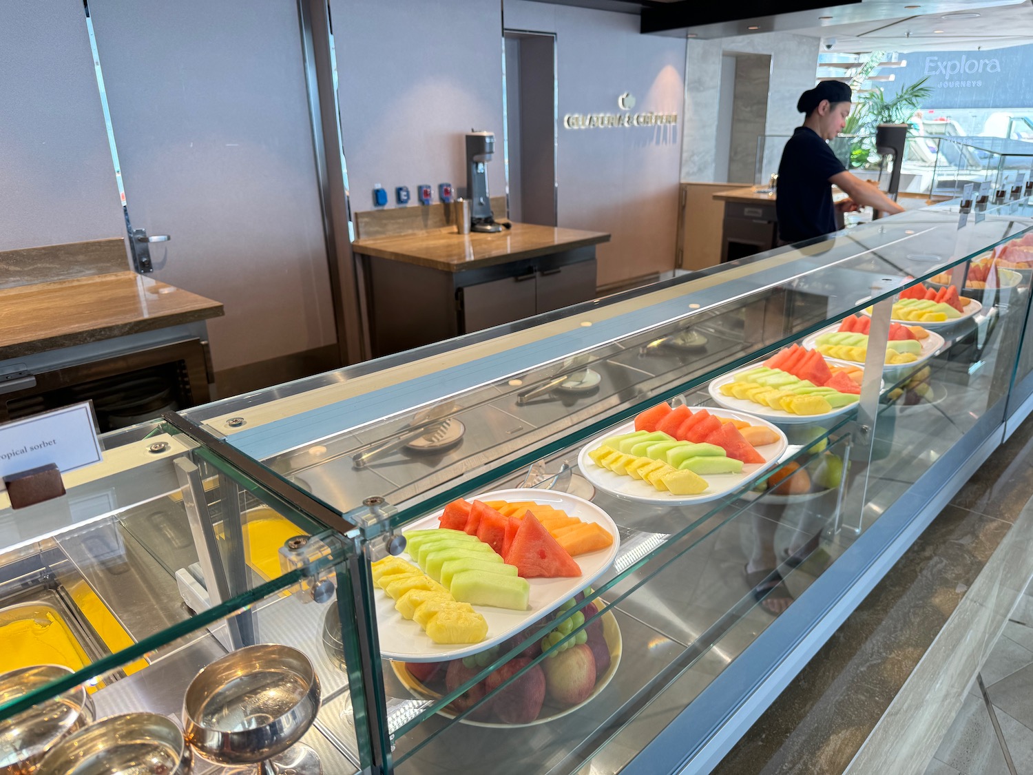 a display case with plates of fruit on it