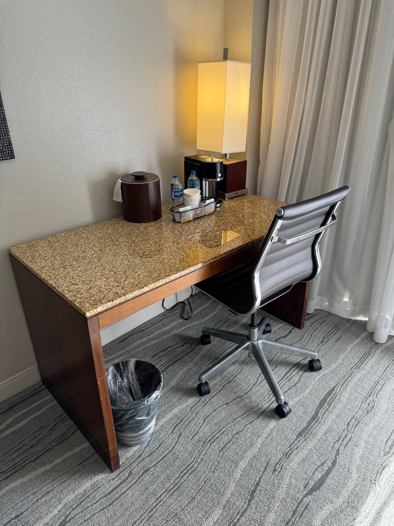 a desk with a chair and a lamp