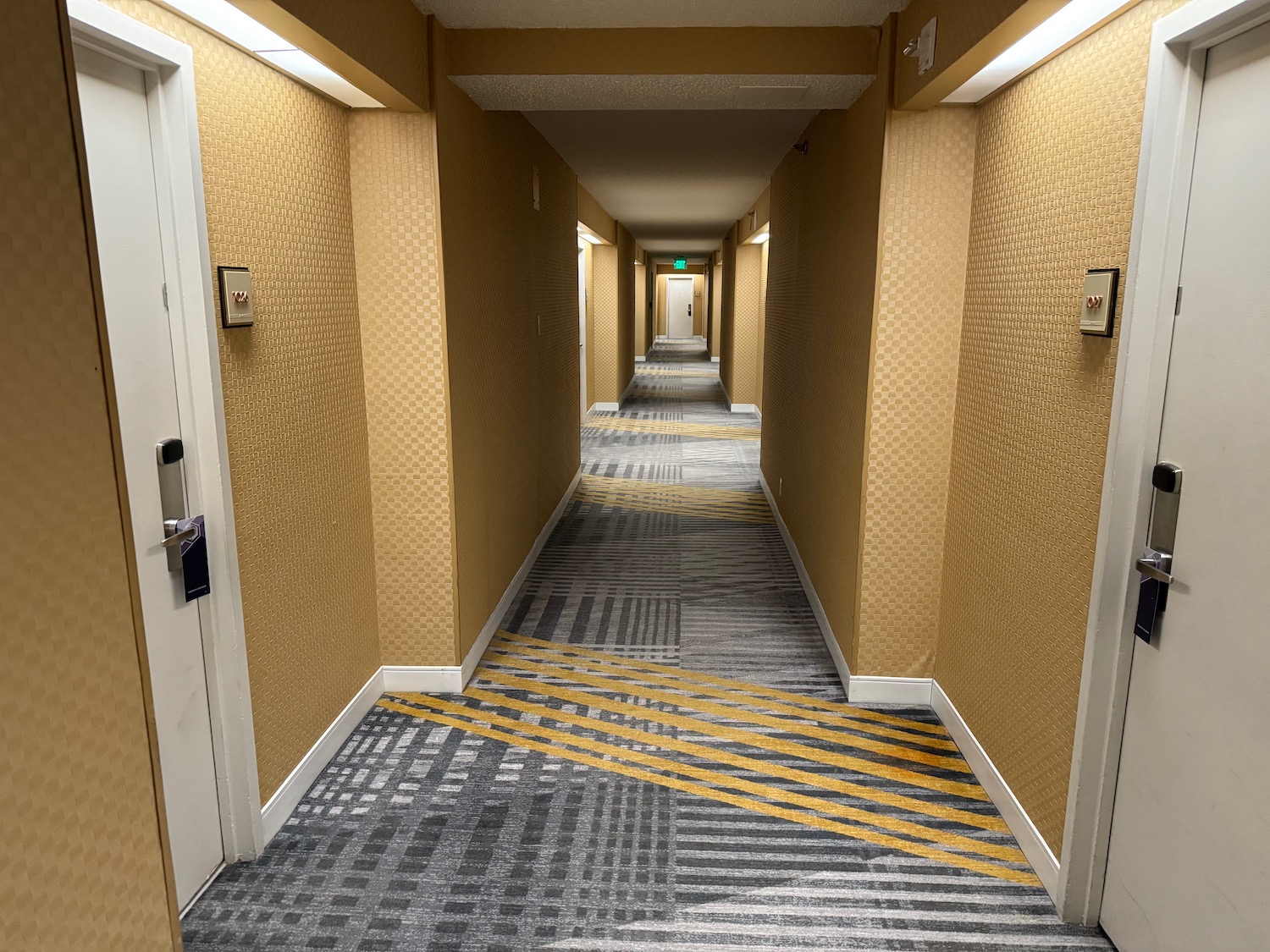 a hallway with yellow and grey carpet