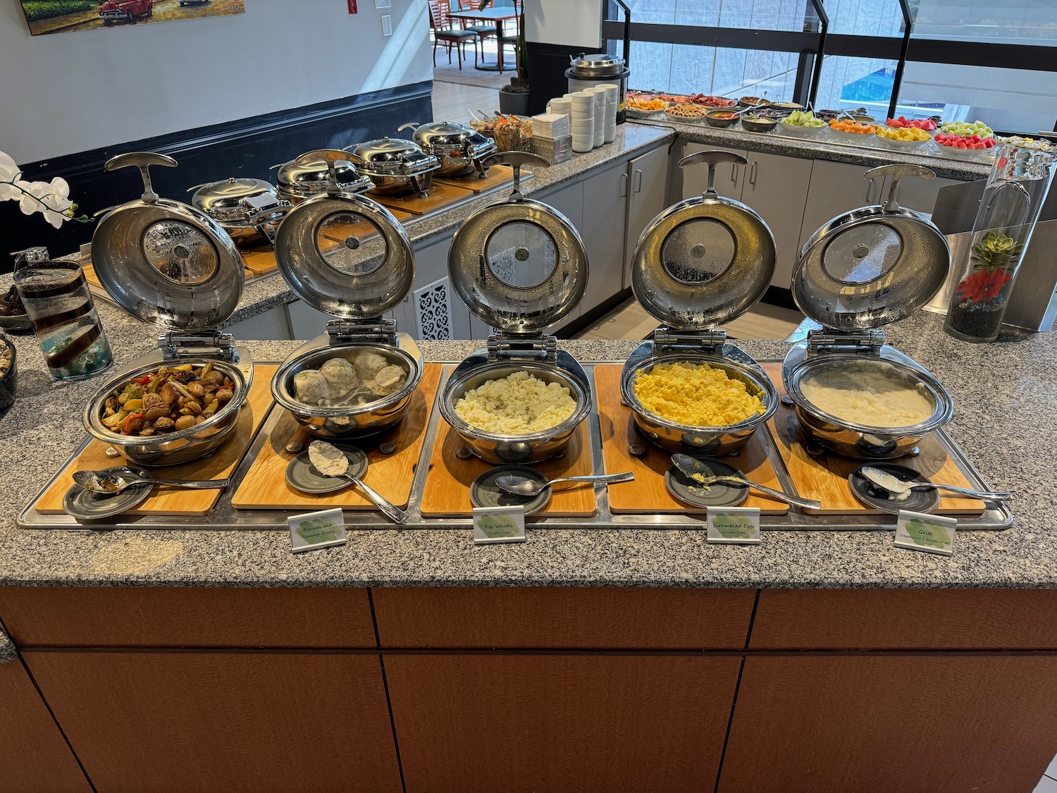 a row of bowls of food on a counter