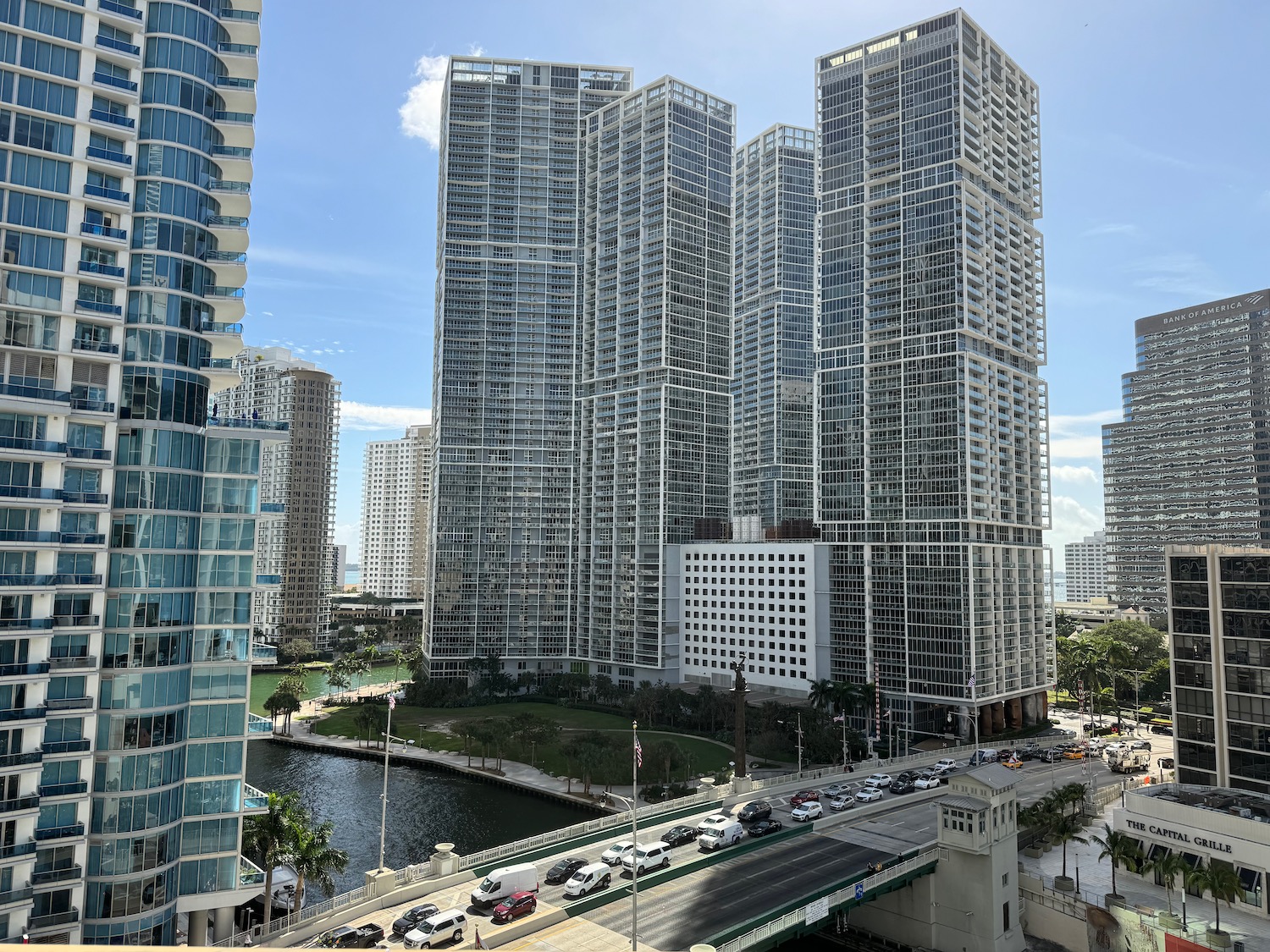 a group of tall buildings with cars on the road