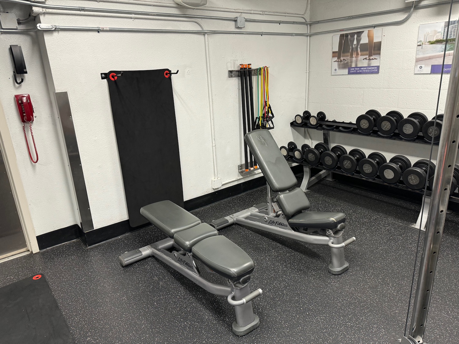 a gym with weights and a bench