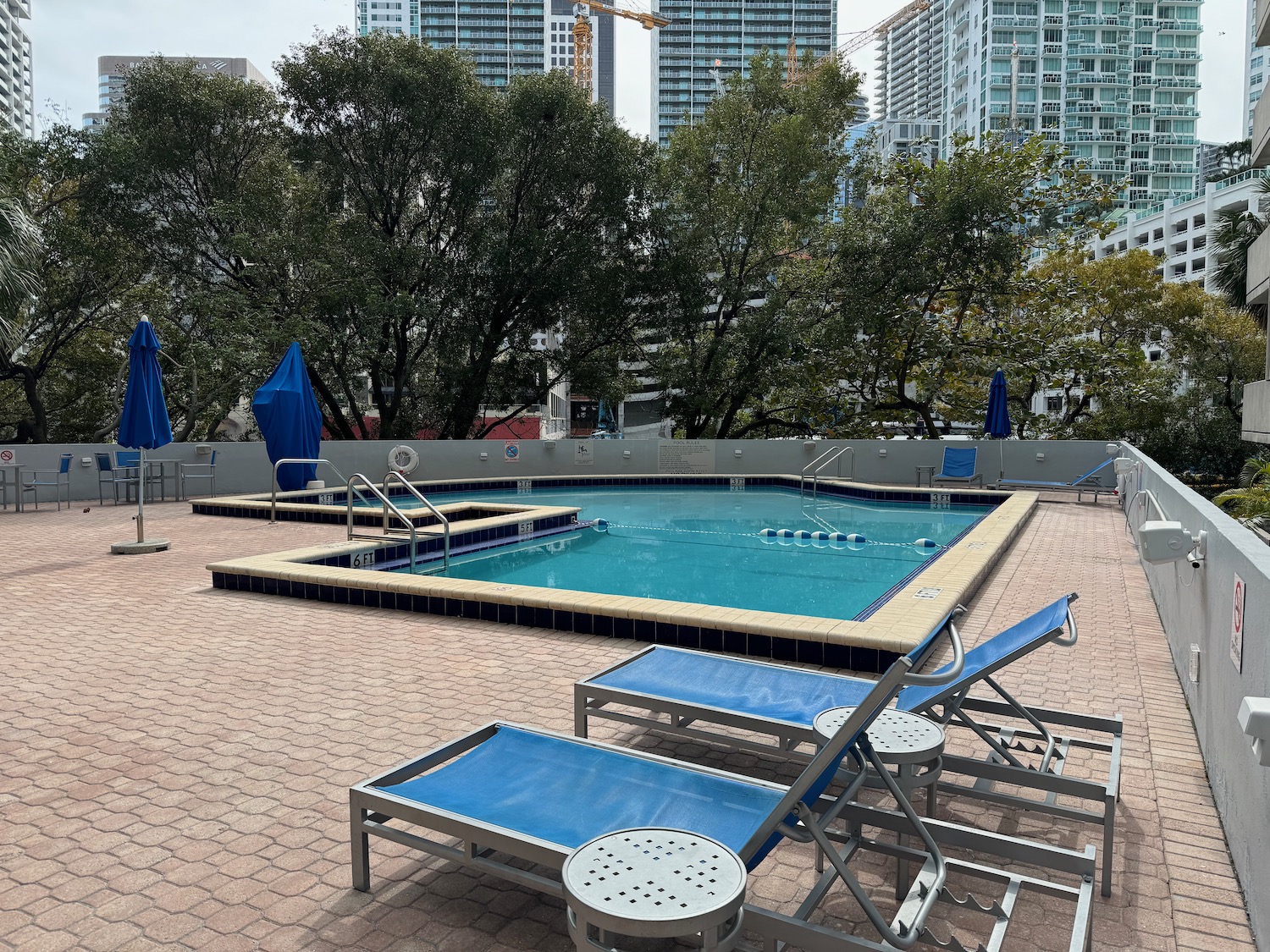 a pool with chairs and umbrellas