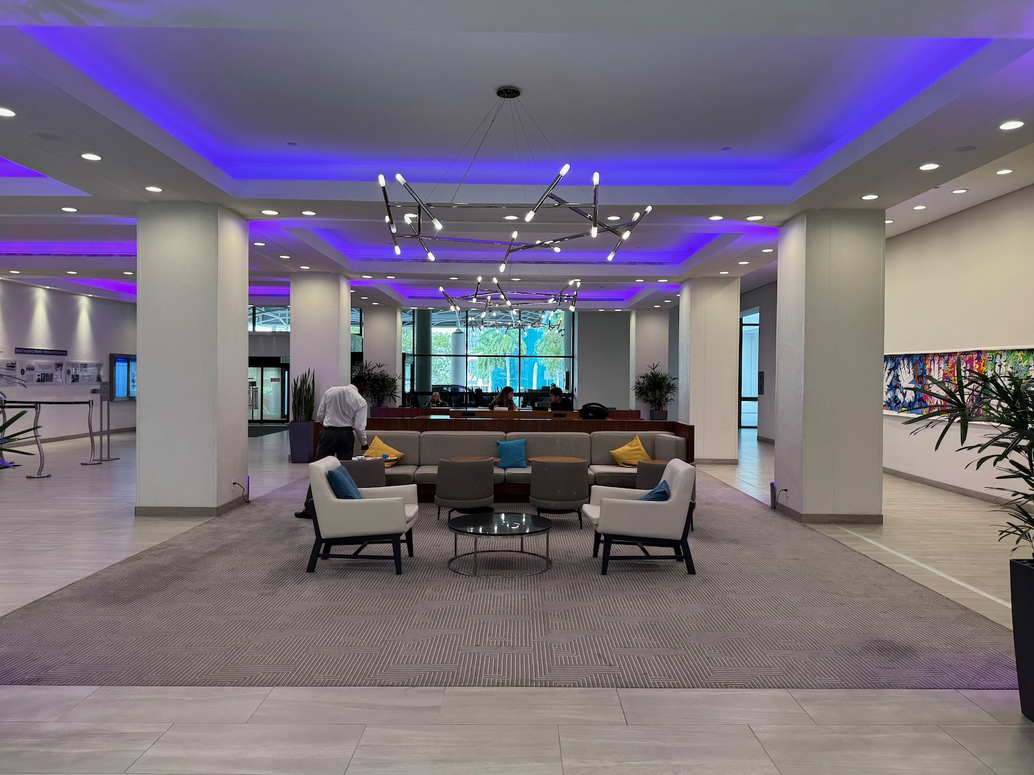 a lobby with a man standing in front of a reception desk