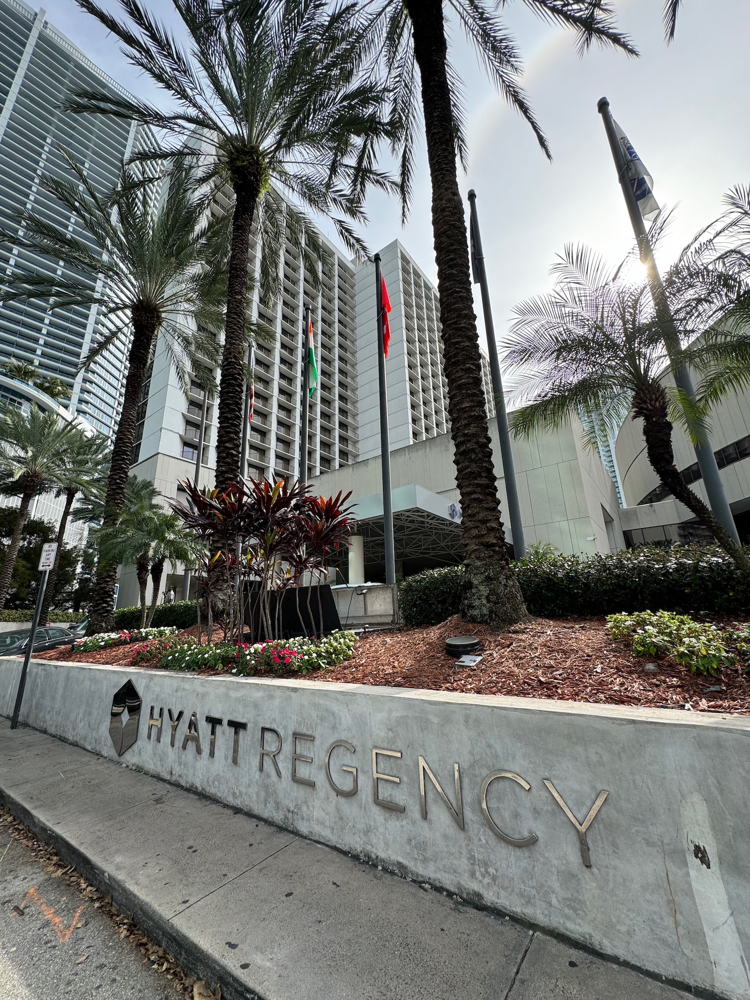 a building with palm trees and a sign