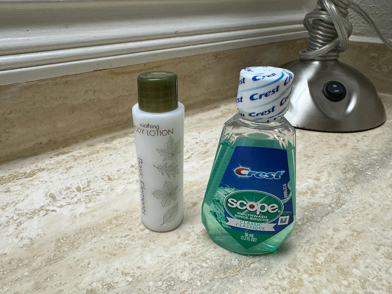 a bottle of mouthwash and lotion on a counter