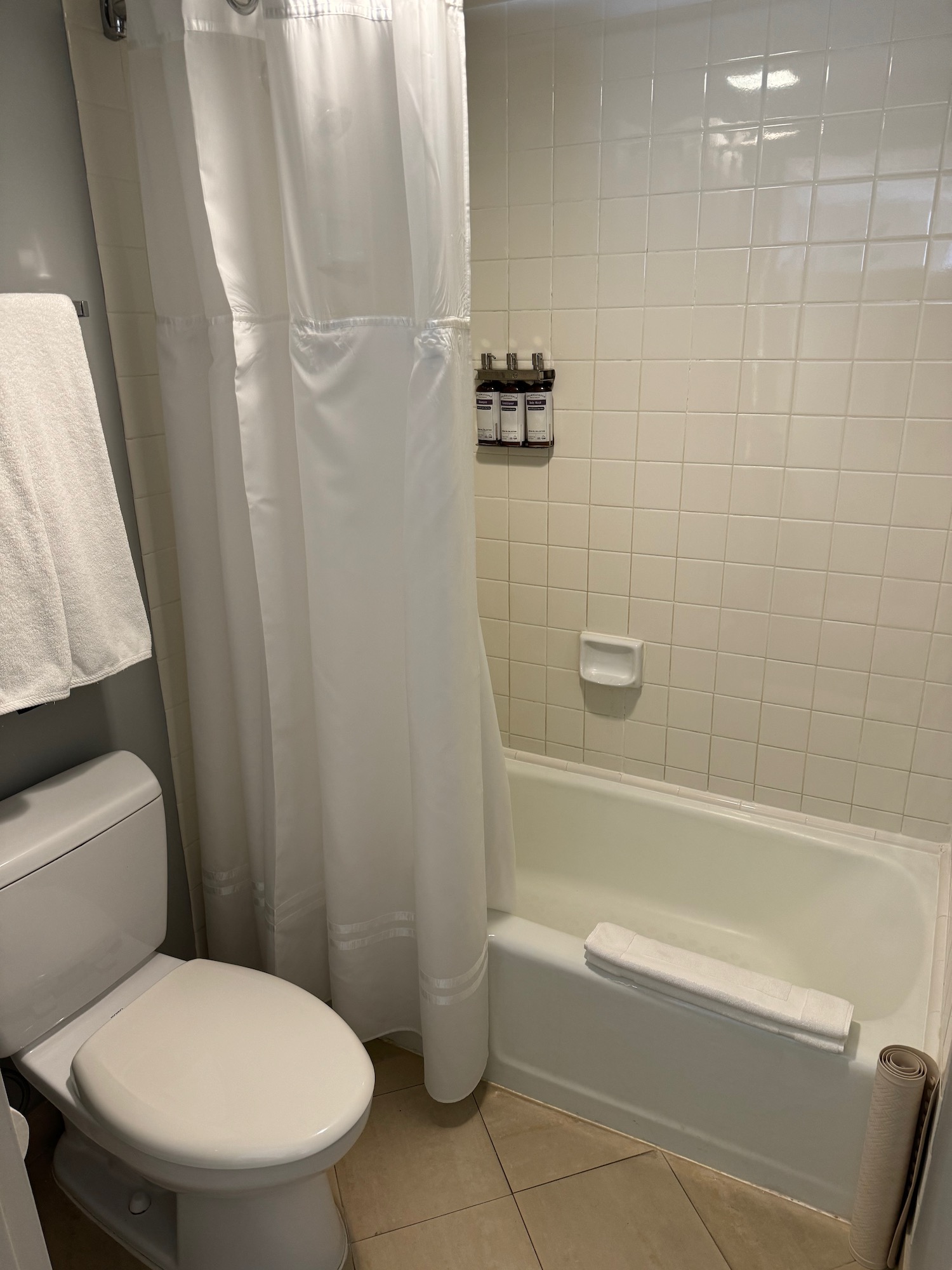 a bathroom with a white shower curtain and bathtub