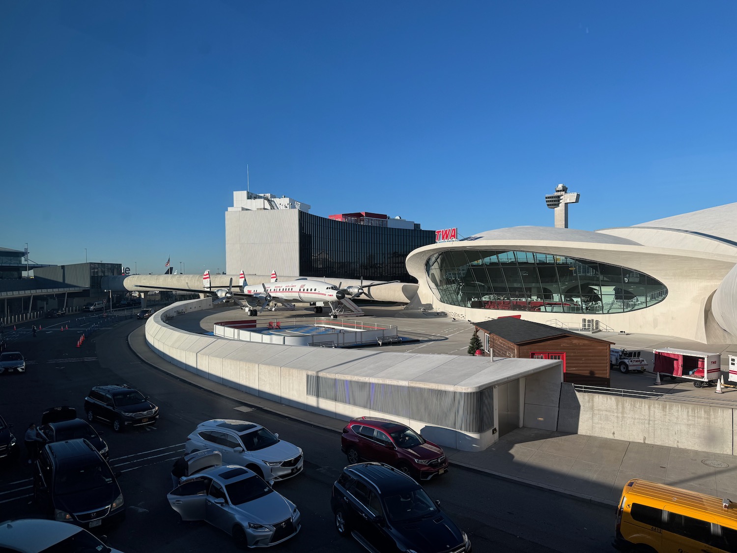 a large white building with a plane on the side