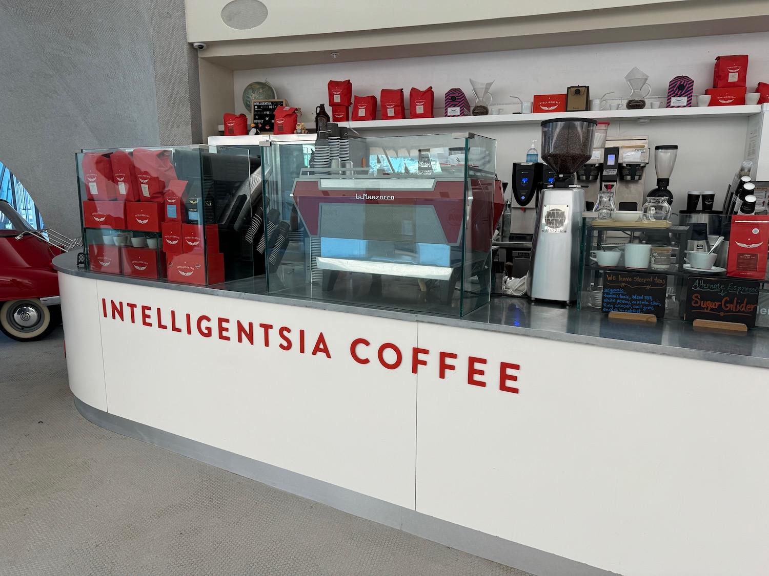 a counter with a glass case and a coffee machine