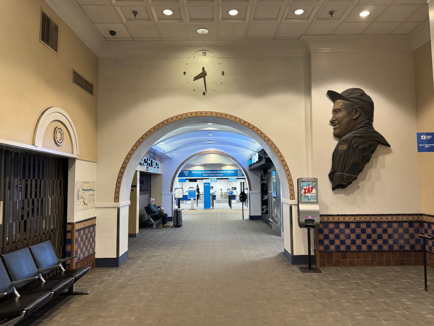 a hallway with a large statue of a man on the wall