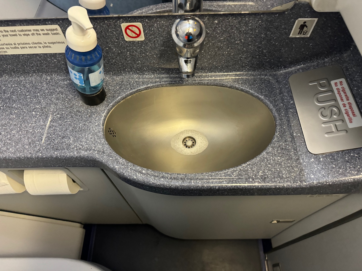 a sink with a bottle of liquid on it