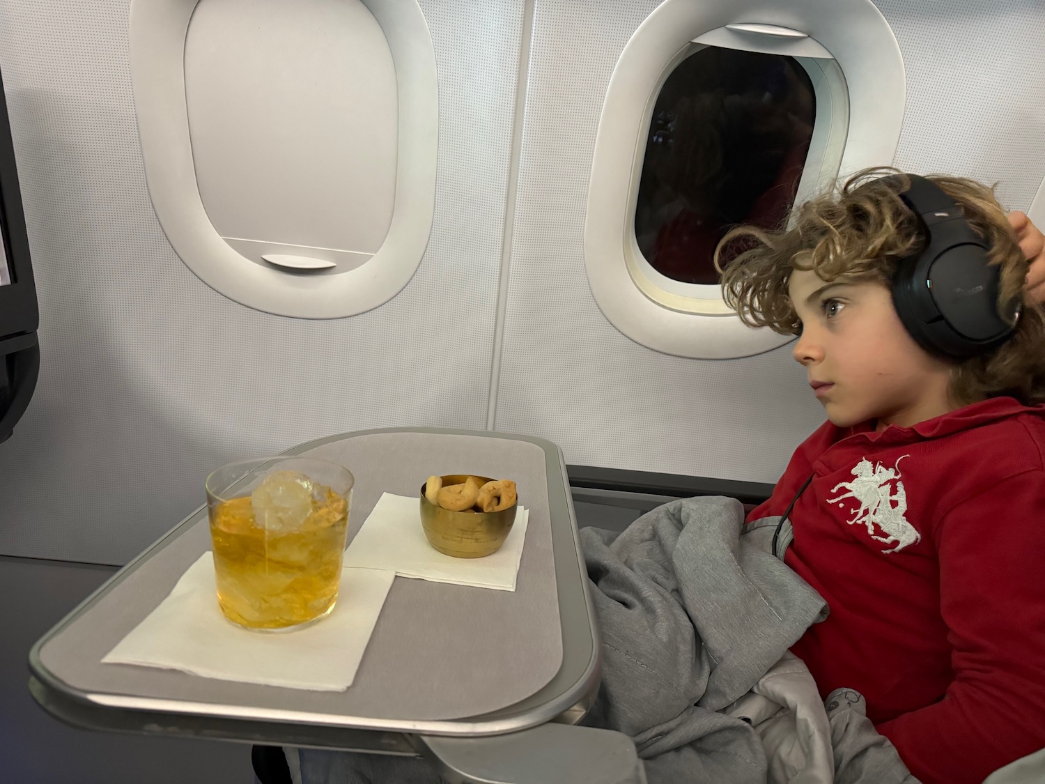 a child sitting in a chair with headphones on