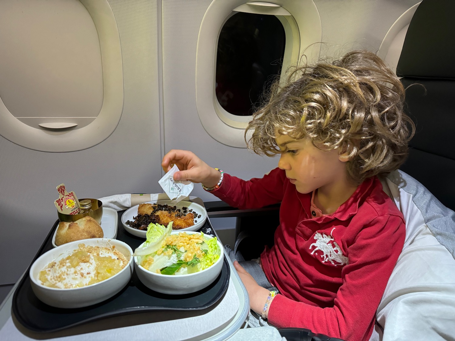 a child sitting in a chair eating food