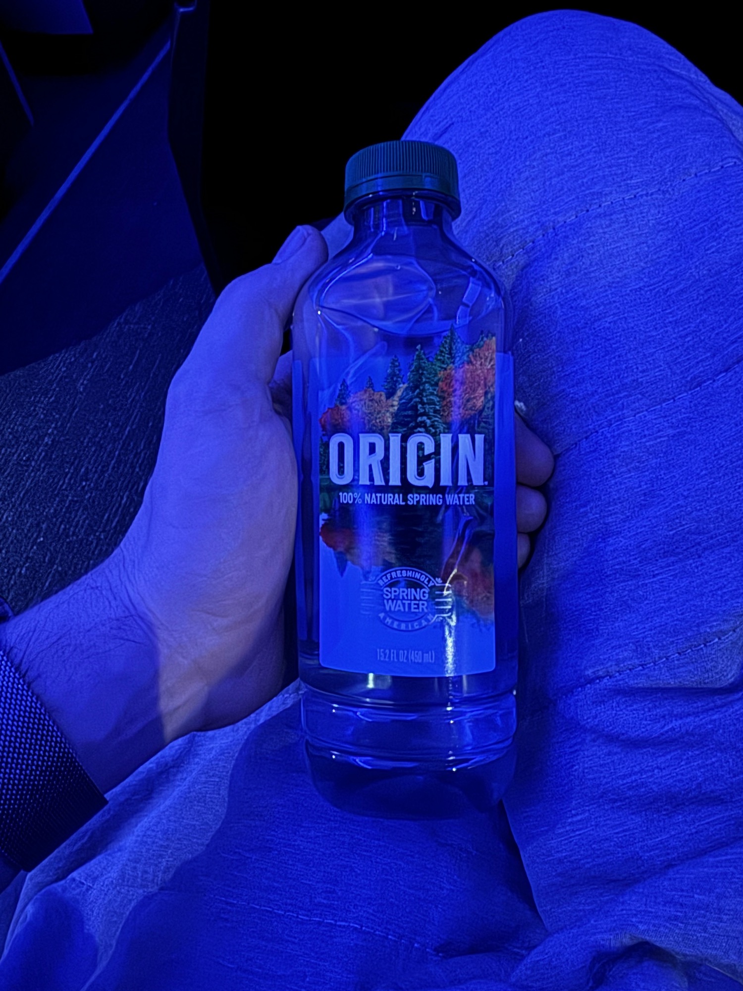 a person holding a bottle of water