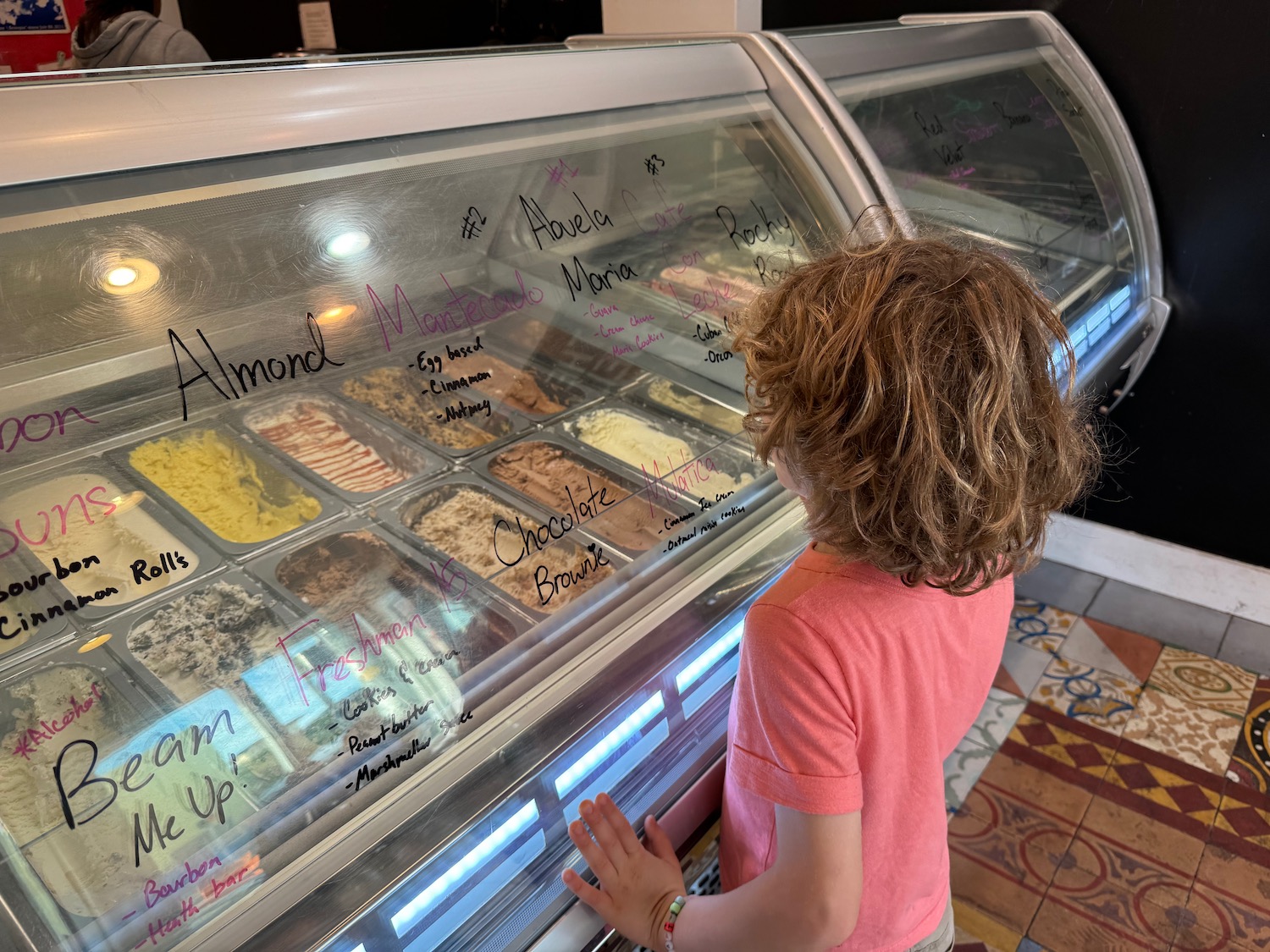 a child looking at food in a case