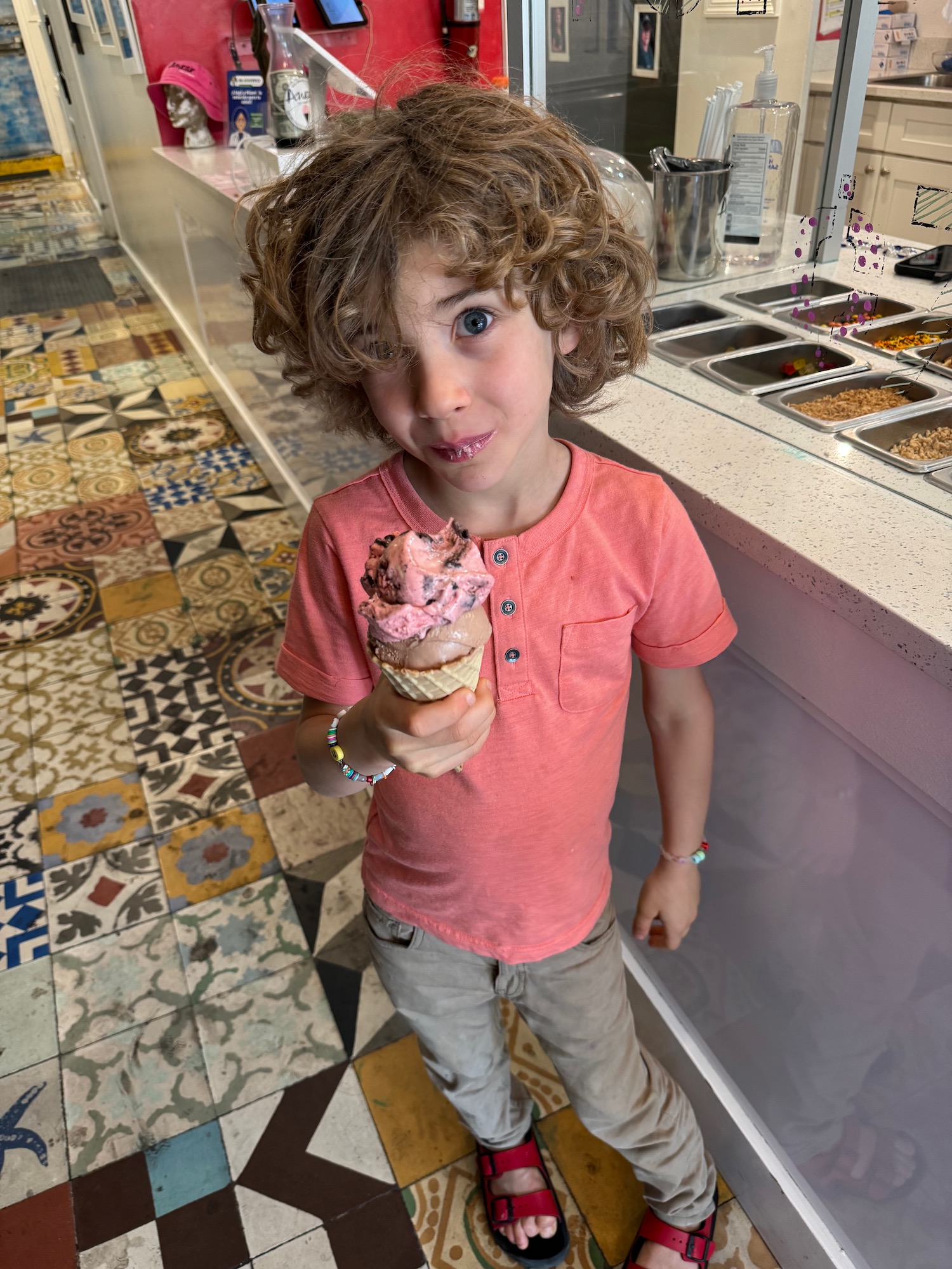 a child holding an ice cream cone