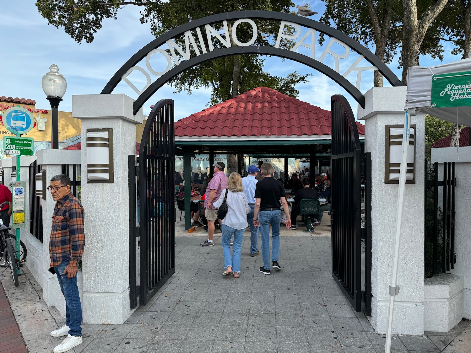 a group of people walking through a gate