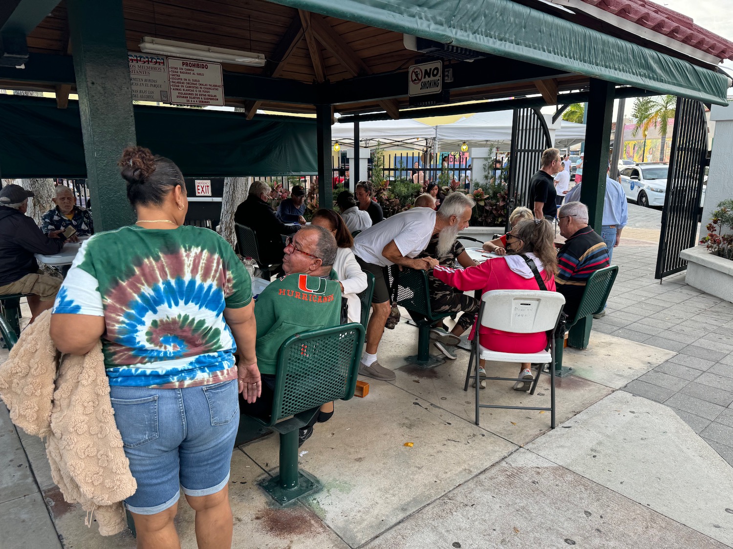 a group of people sitting at tables outside