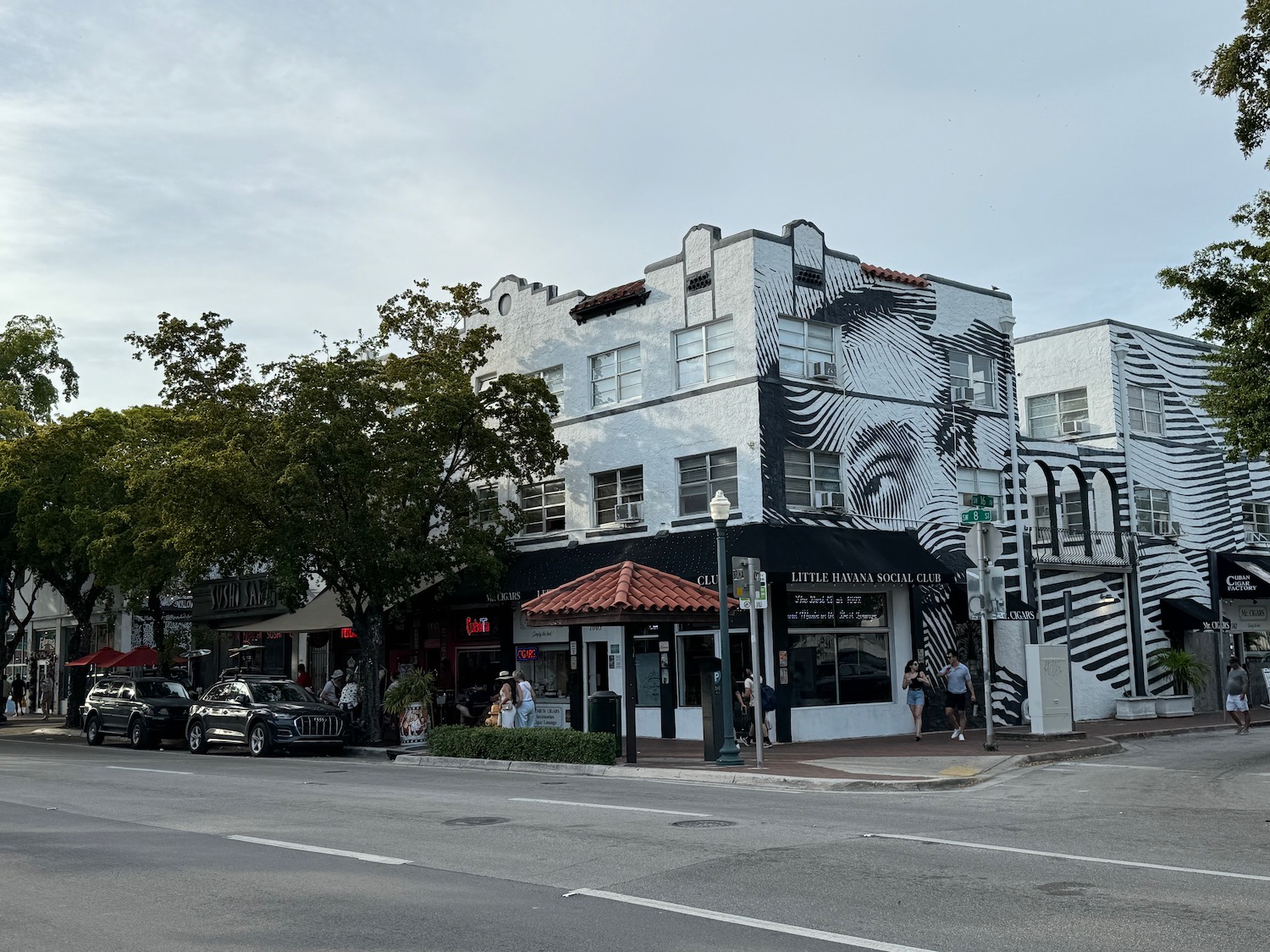 a street corner with a mural on the side of a building