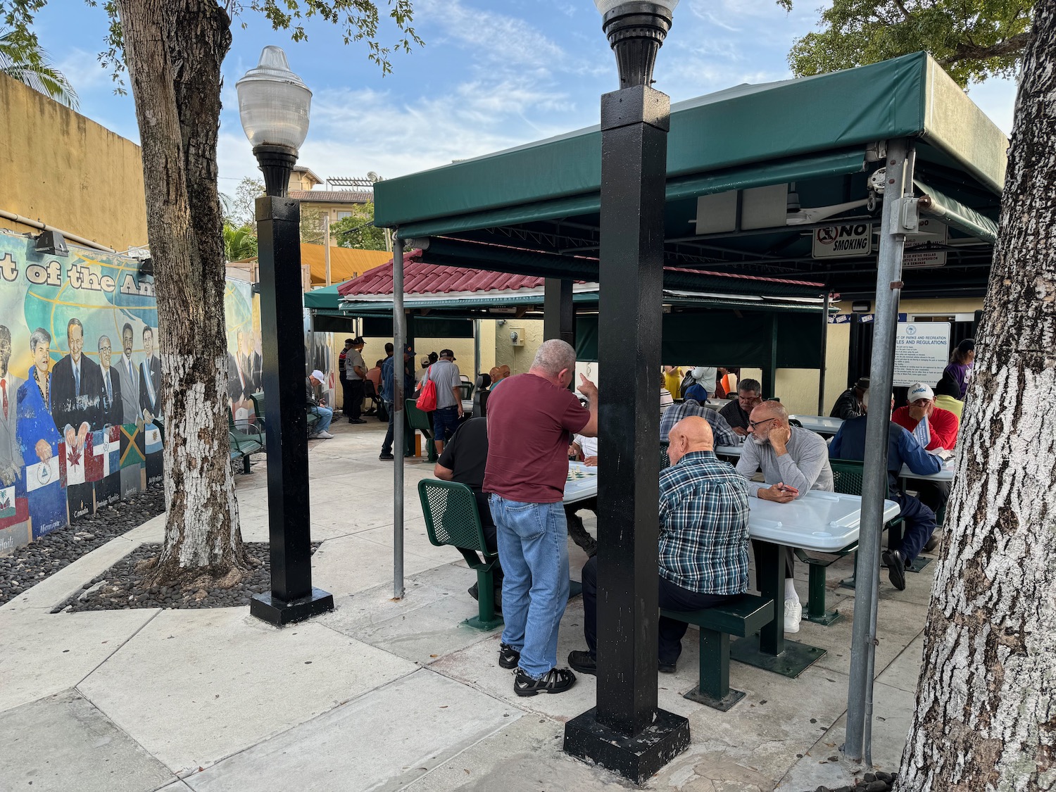 a group of people sitting at tables outside