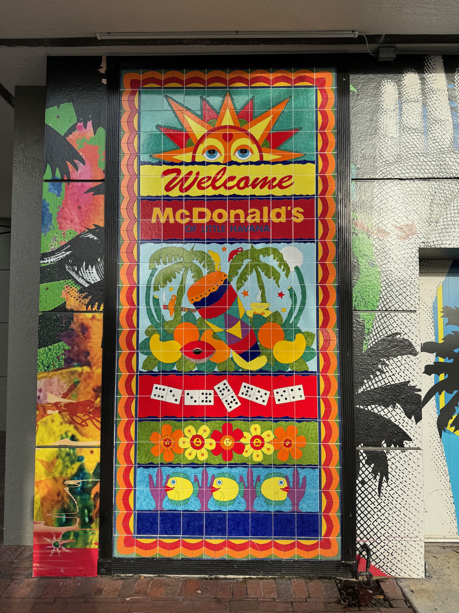 a sign with colorful art on the wall