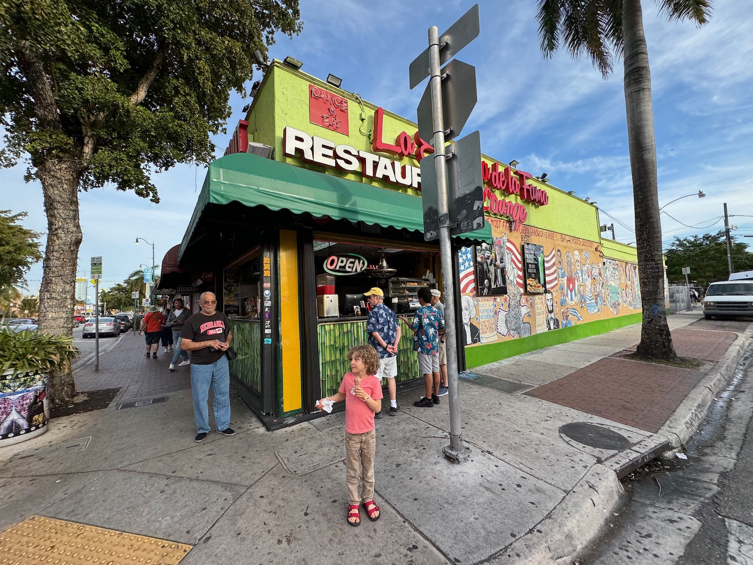 a group of people standing outside a restaurant