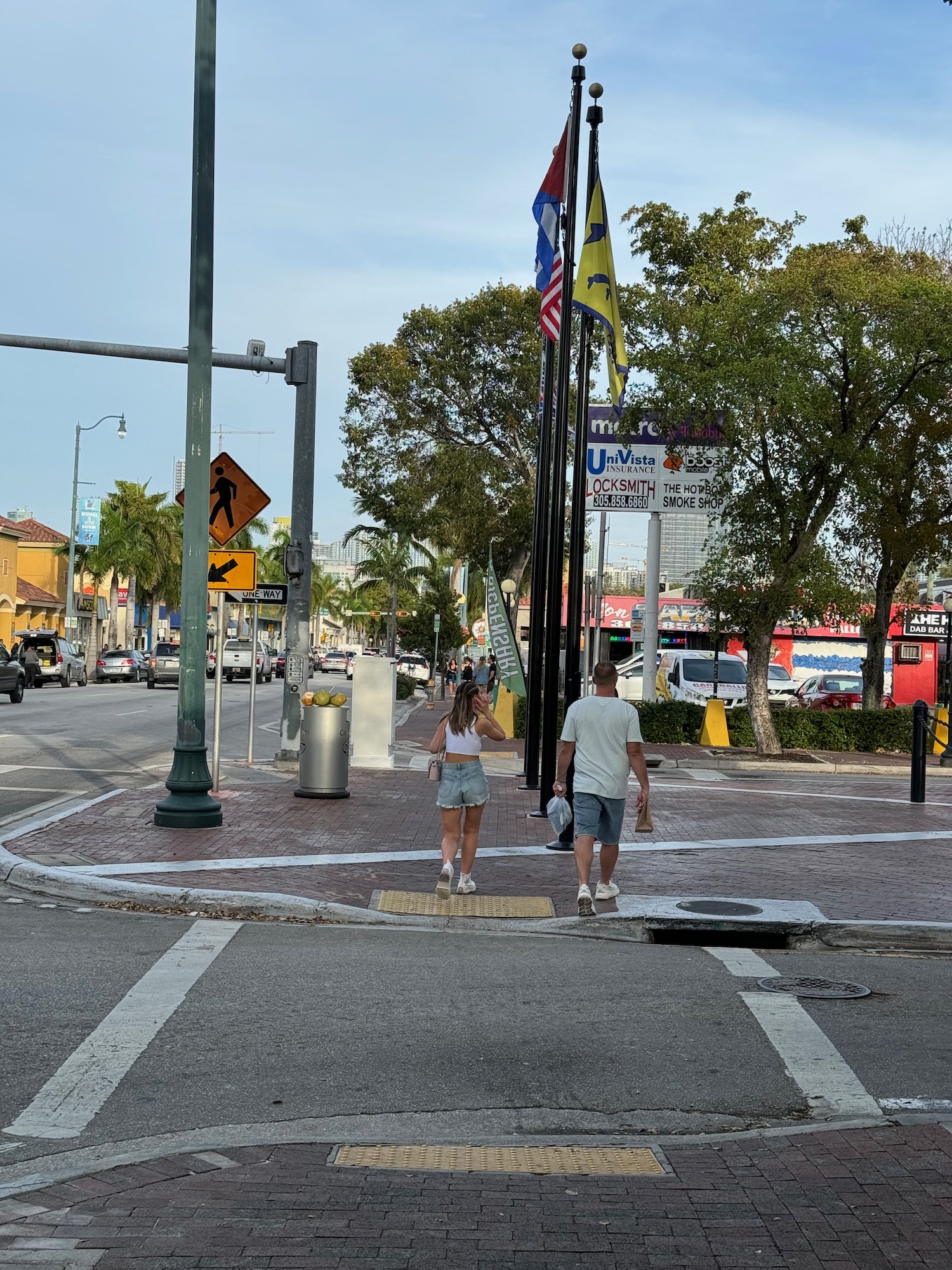 a man and woman walking on a street corner