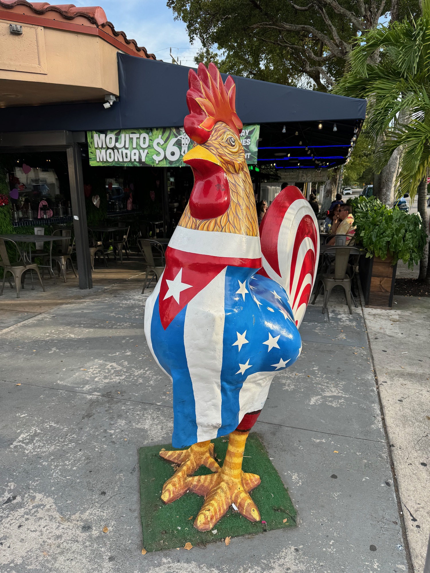 a statue of a rooster with a flag on it