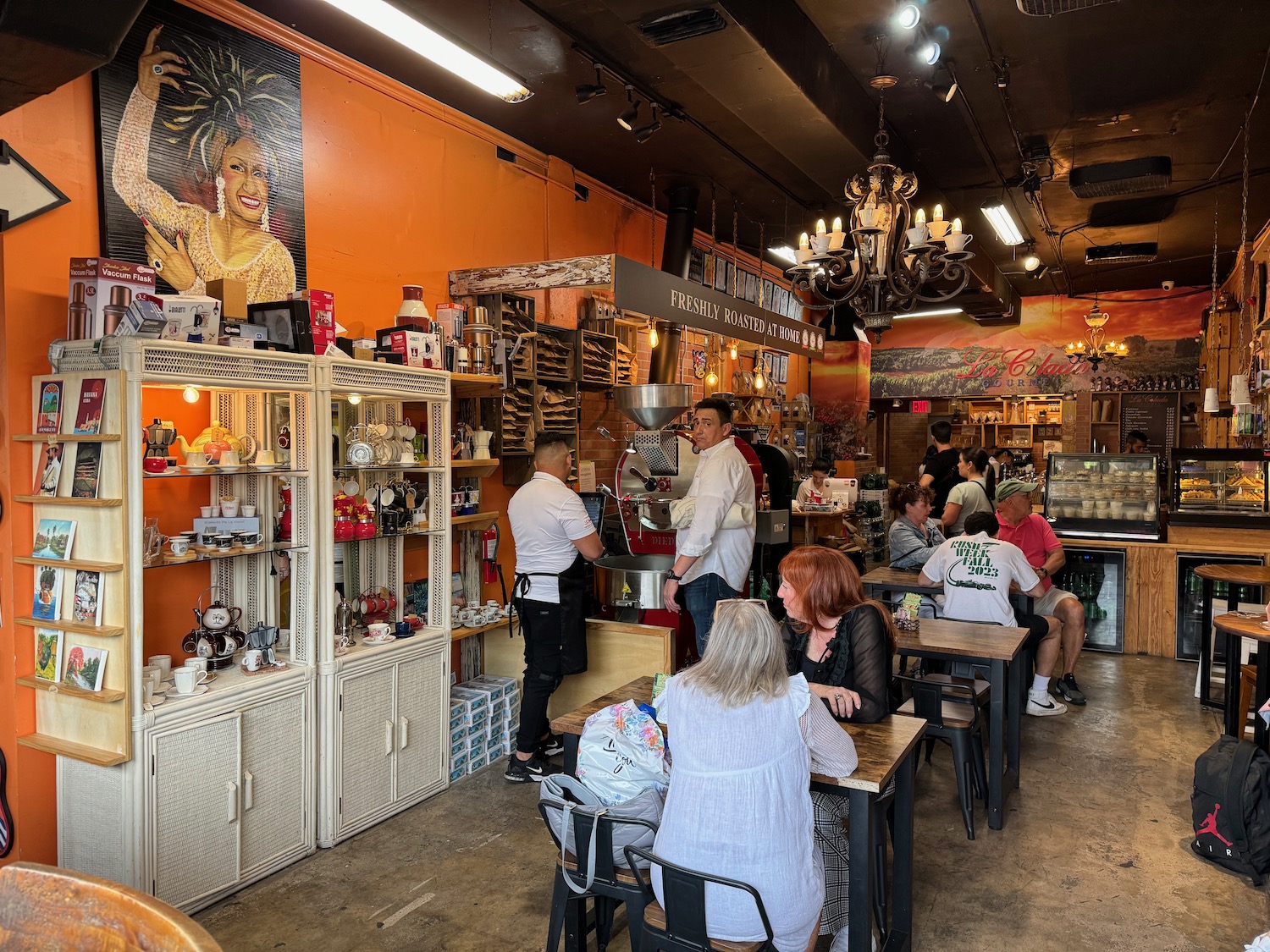 a group of people sitting at tables in a restaurant