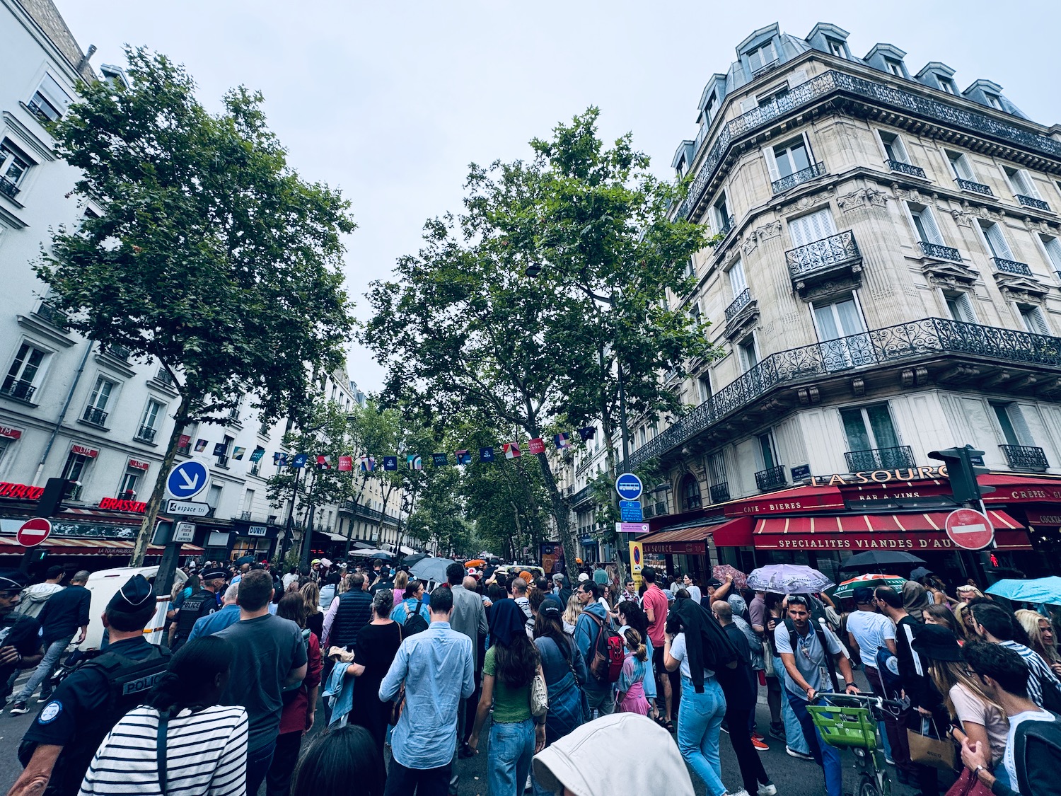 a crowd of people walking on a street