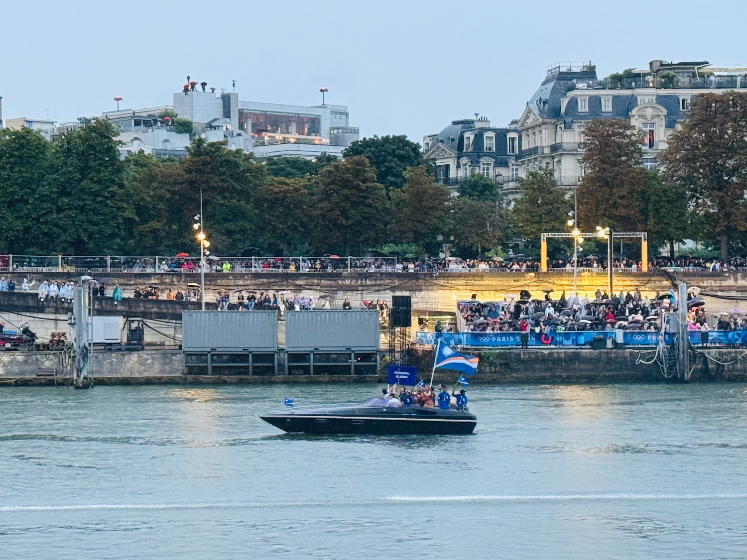 a boat on the water with people watching