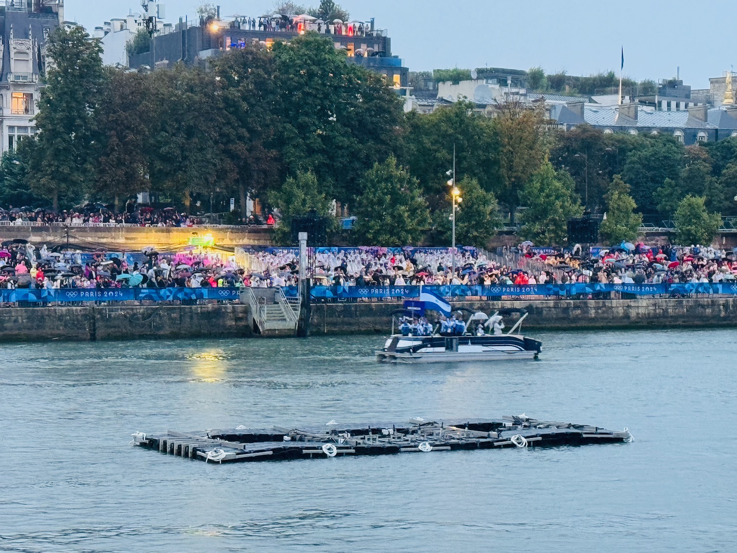 a boat on the water with a crowd of people watching