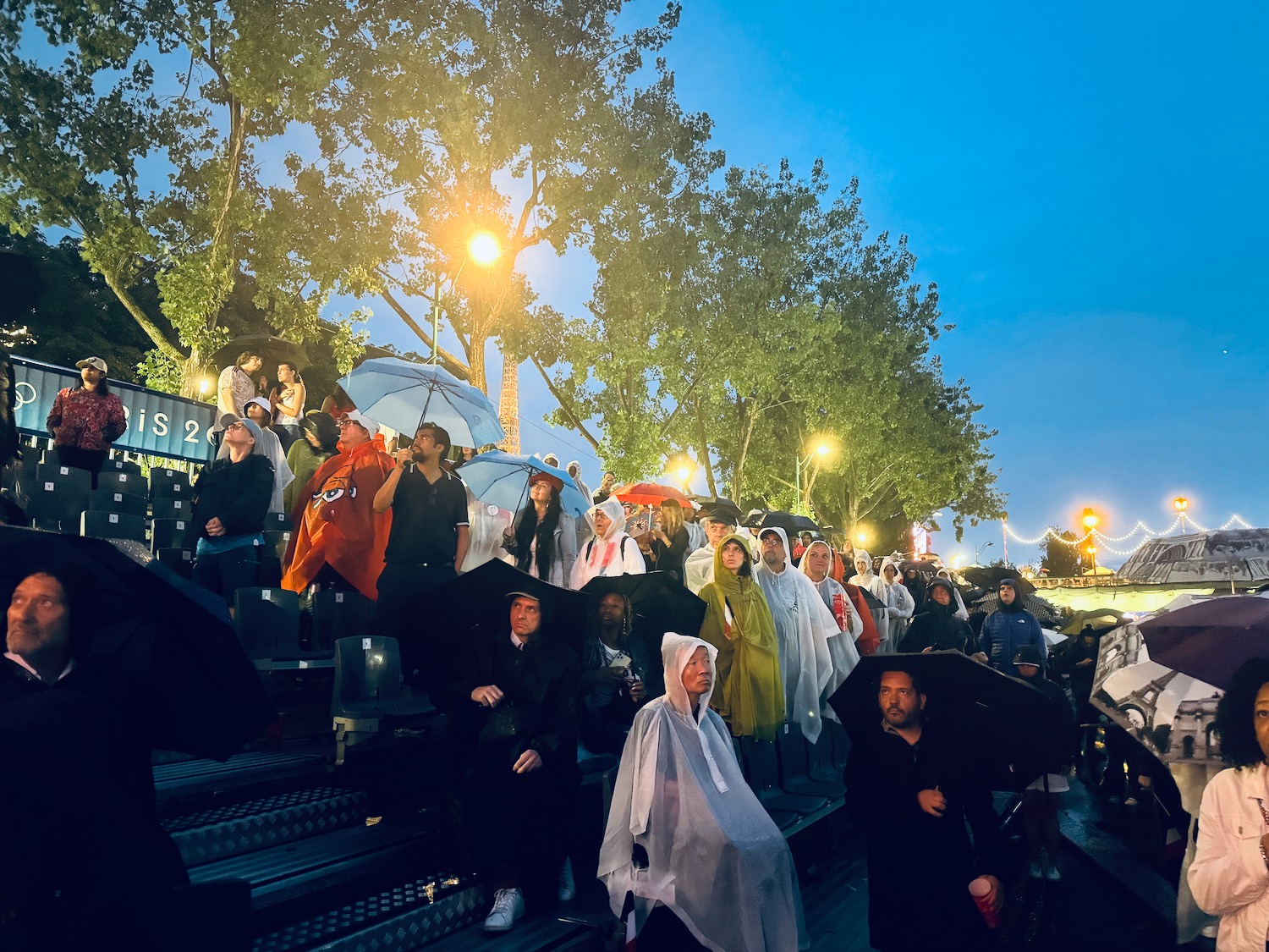 a group of people standing on stairs with umbrellas