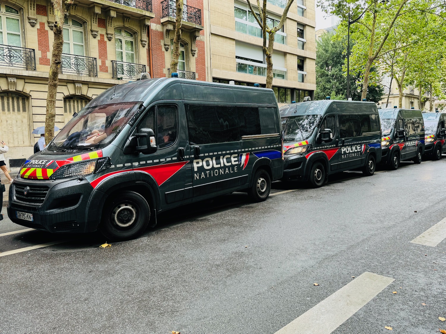 a group of police vans parked on a street