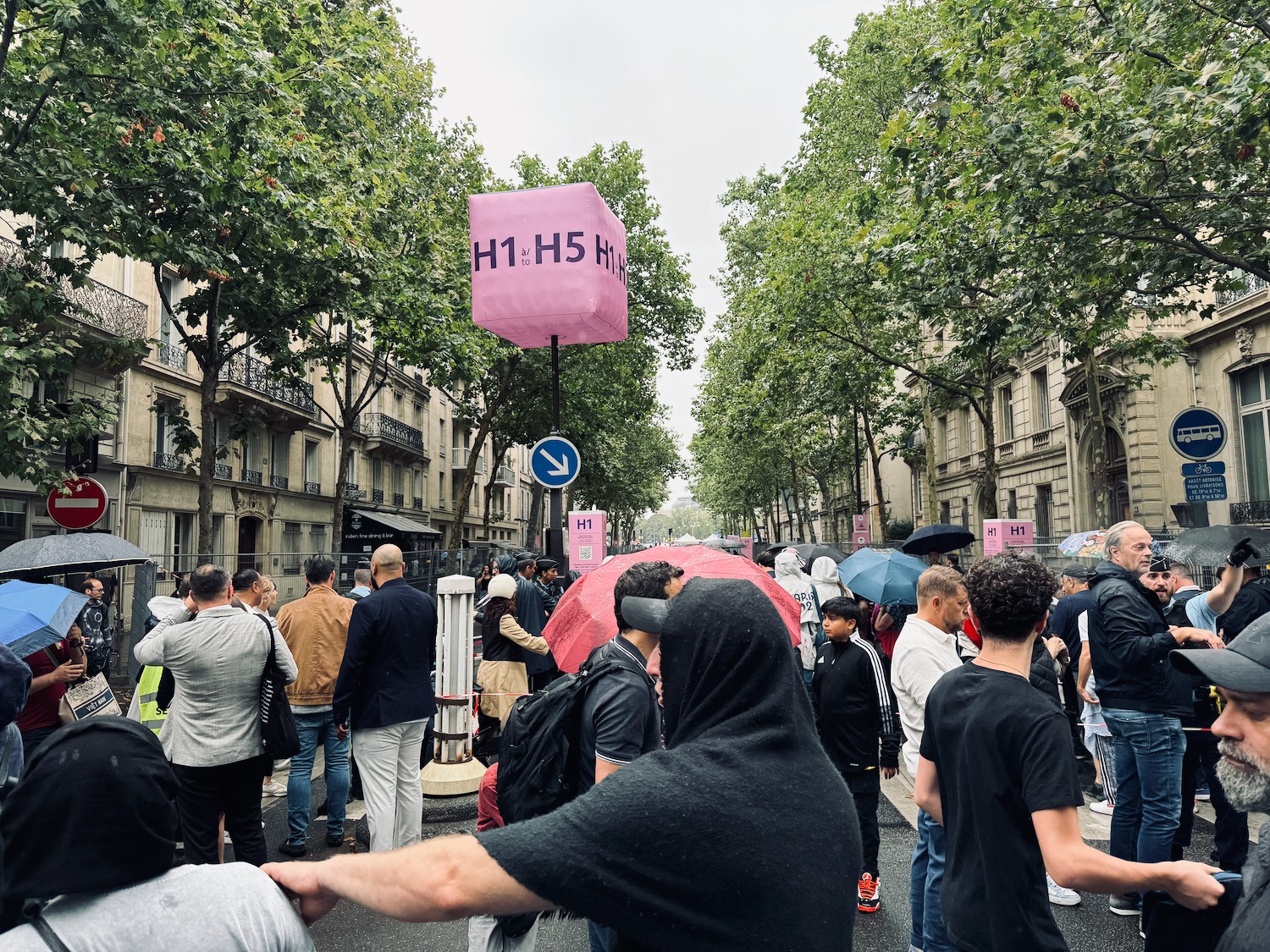 a group of people walking on a street with umbrellas