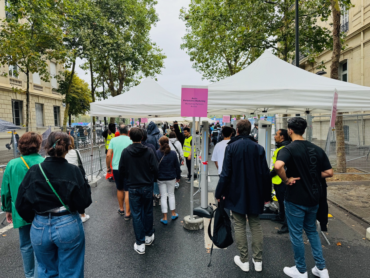 a group of people standing in a line outside a tent