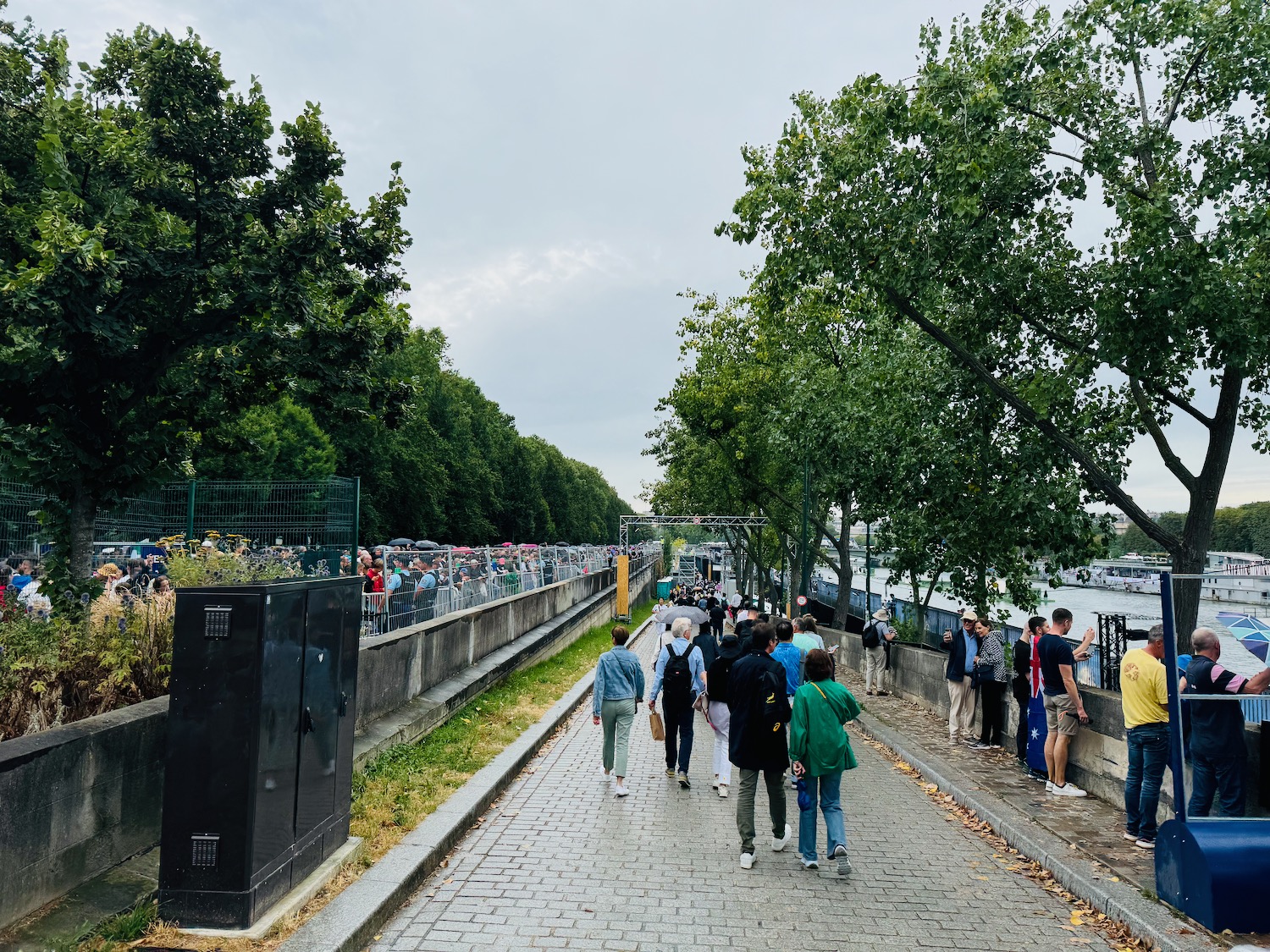 a group of people walking on a brick path